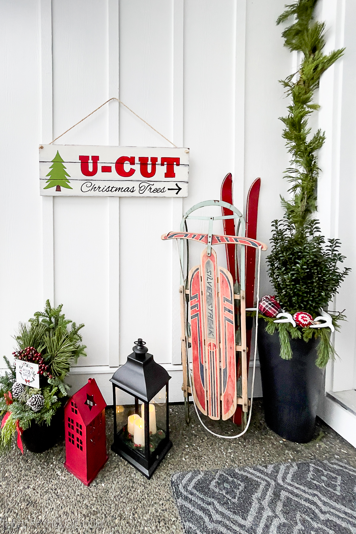 A cheerful DIY U-Cut Christmas Trees sign.