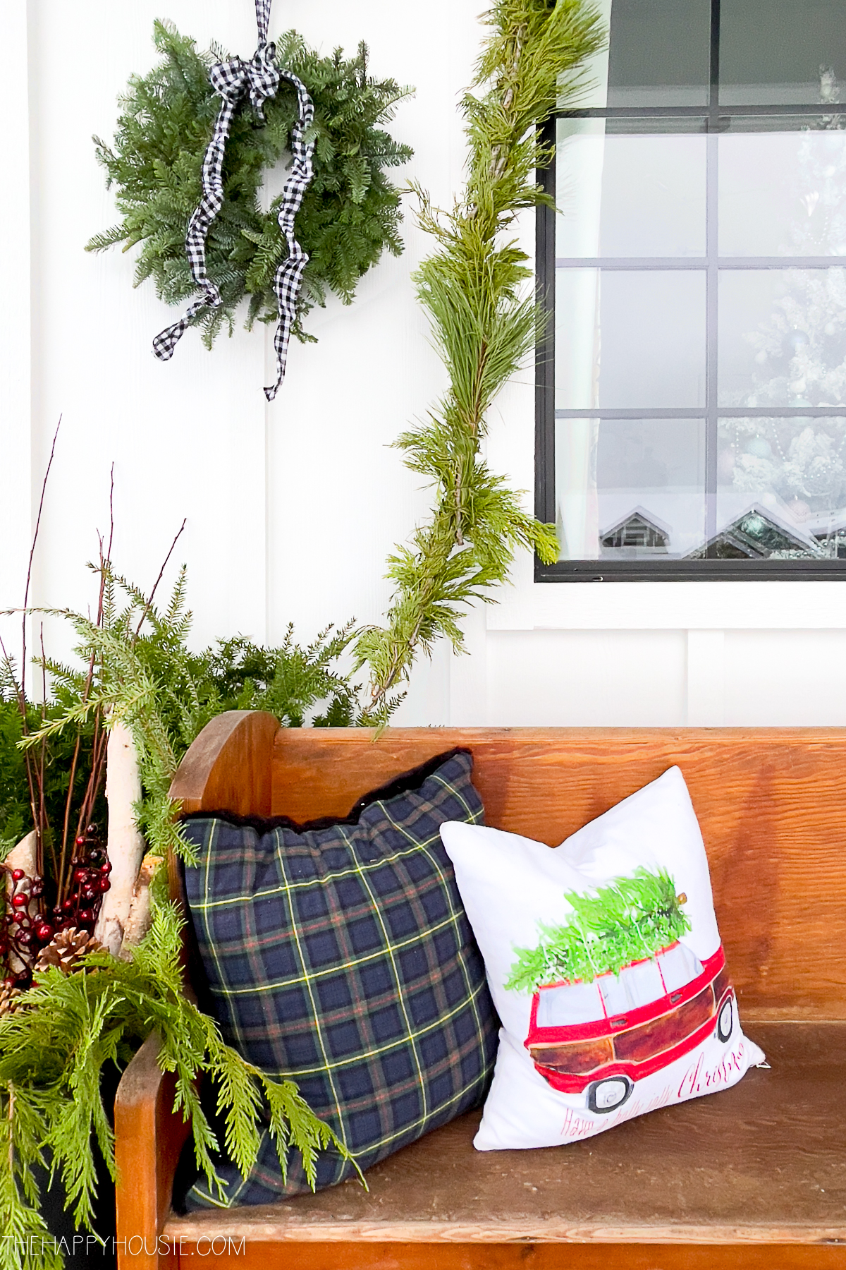 Cheerful holiday pillows displayed on a vintage pew 