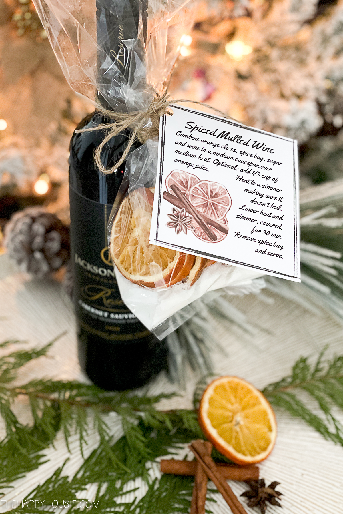 a bottle of red wine with a mulling spice sachet and instructions for making mulled wine as a DIY Christmas gift idea