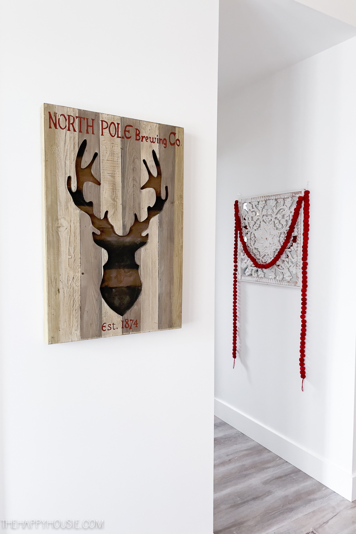 Wooden picture of a deer with antlers.