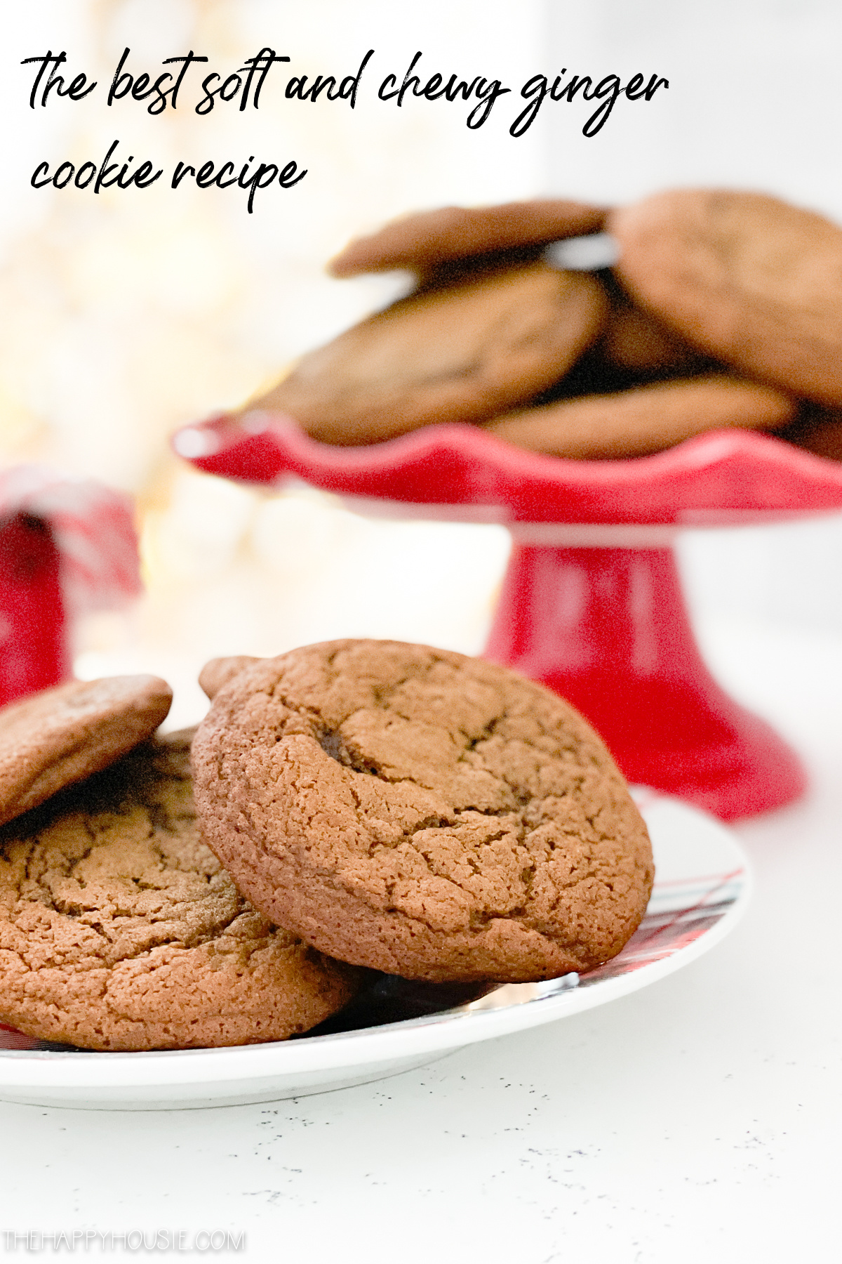 soft and chewy ginger cookies on a plate and on a tray in the background