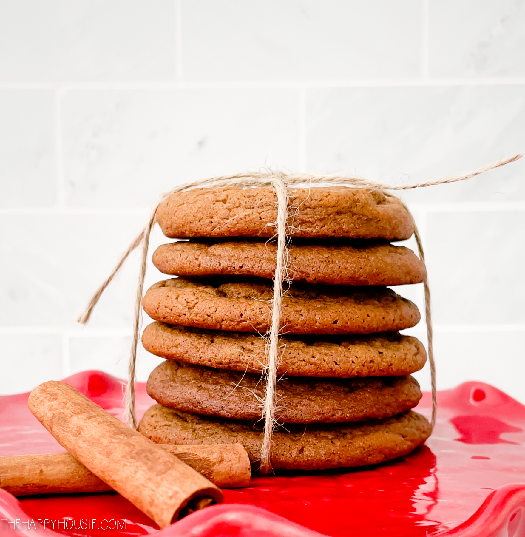 six soft and chewy ginger cookies layered and stacked together and tied up with twine
