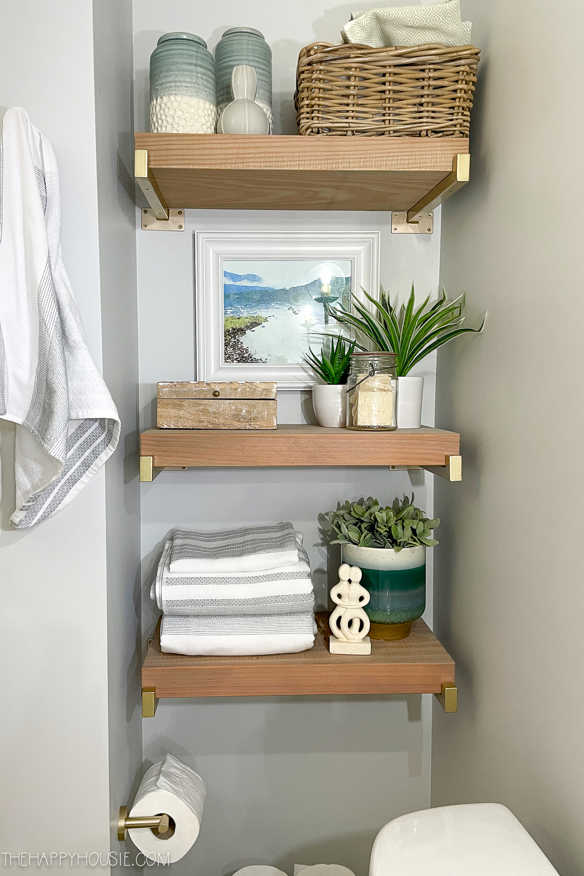 Wood shelves in recessed alcove of bathroom.