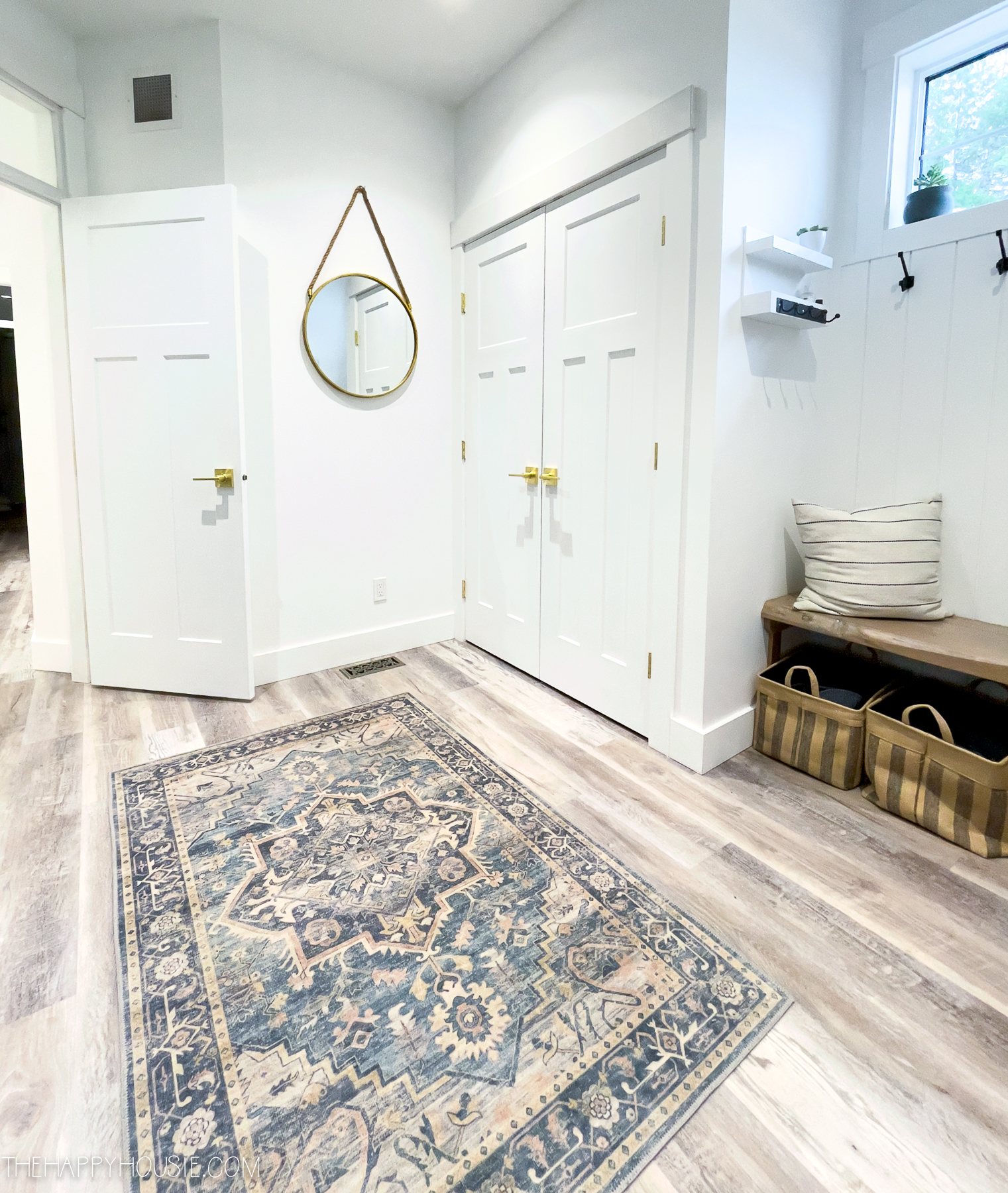 The entryway with a small area rug by the door.