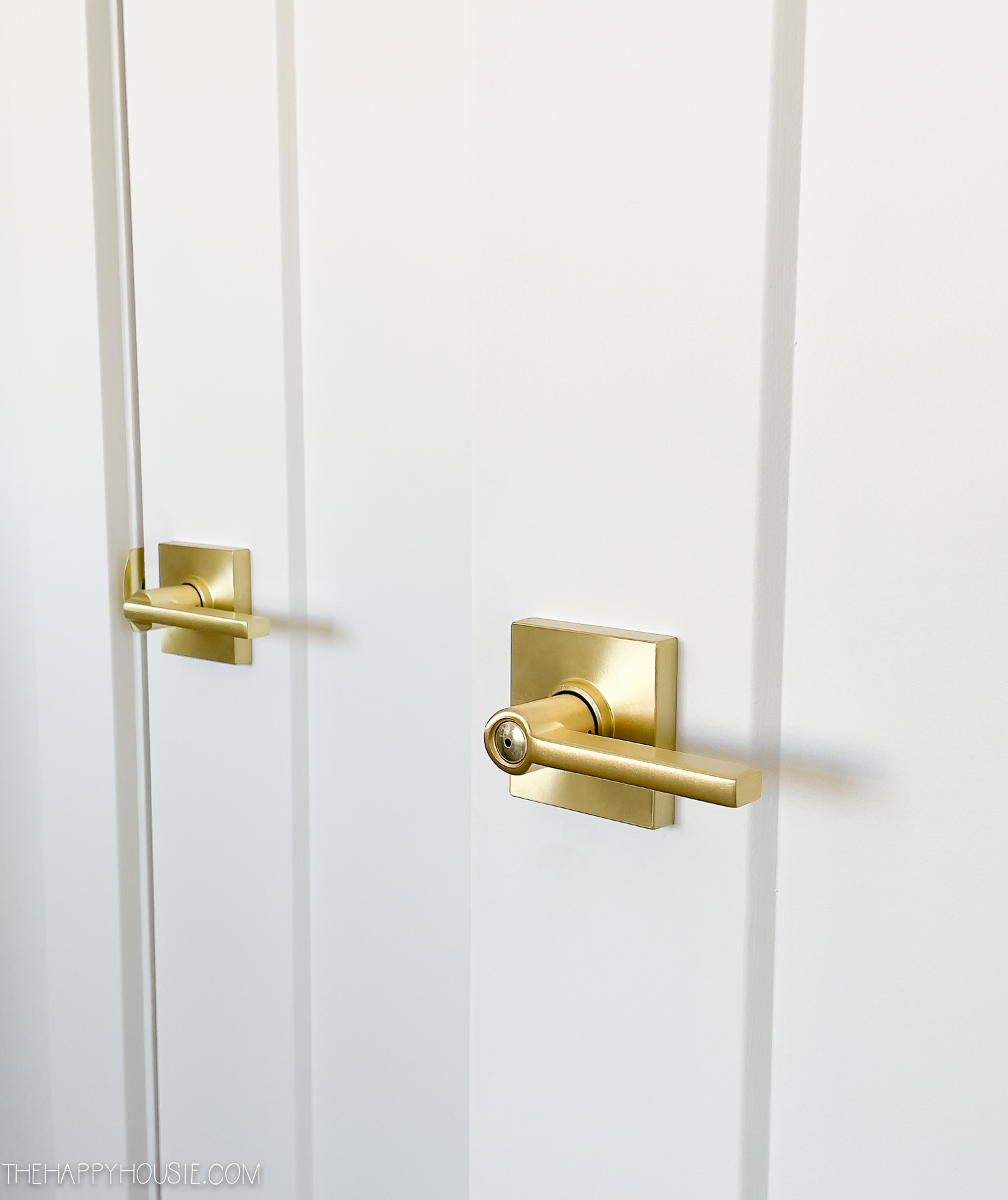 Gold Schlage Latitude lever set with Collins Trim in Satin Brass Finish on two doors in a home