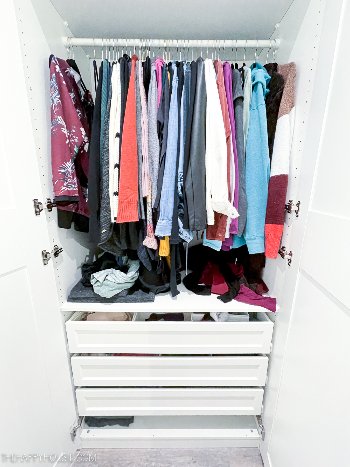 clothings in a disorganized bedroom closet