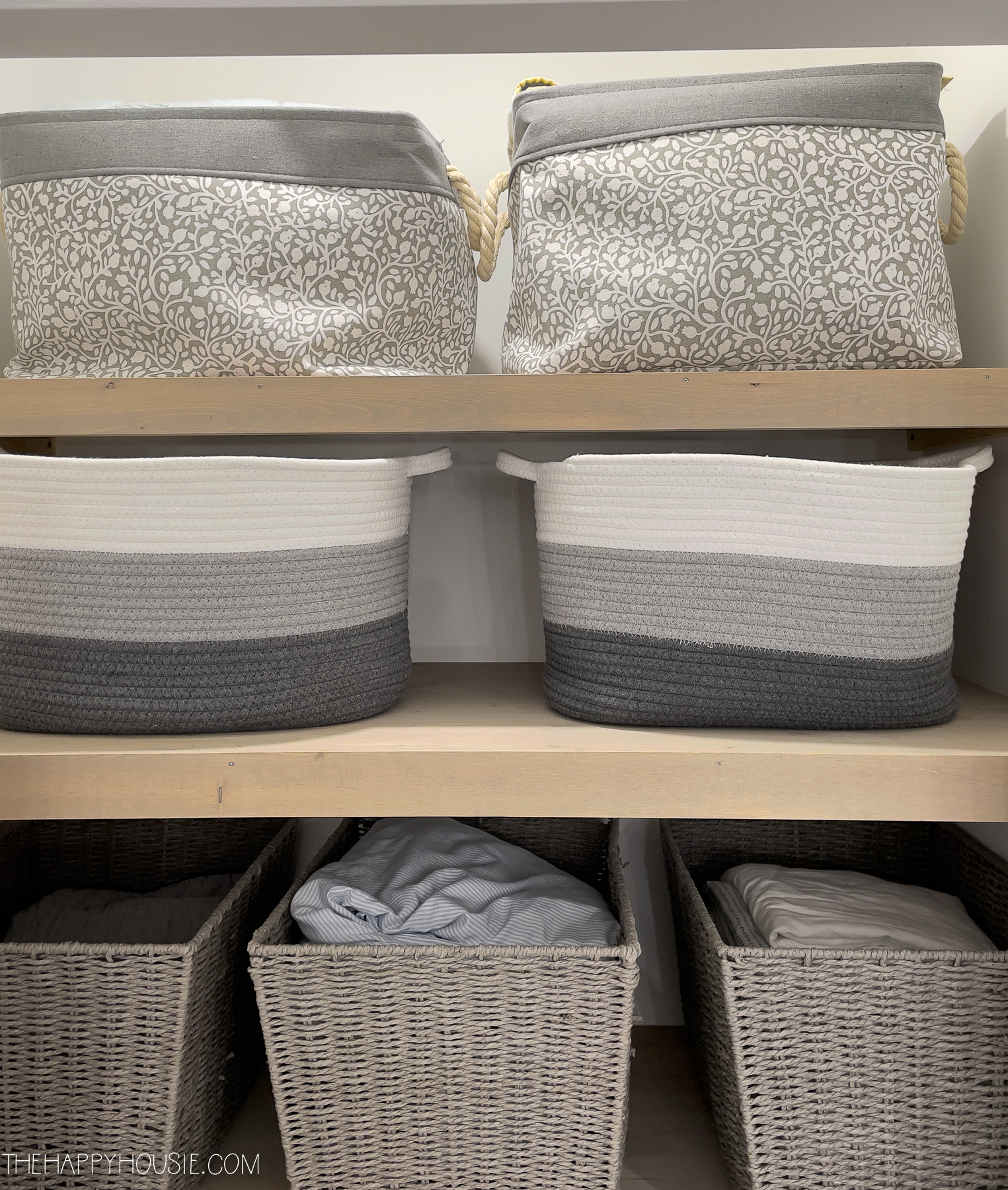 The shelves with the baskets and the linen inside.