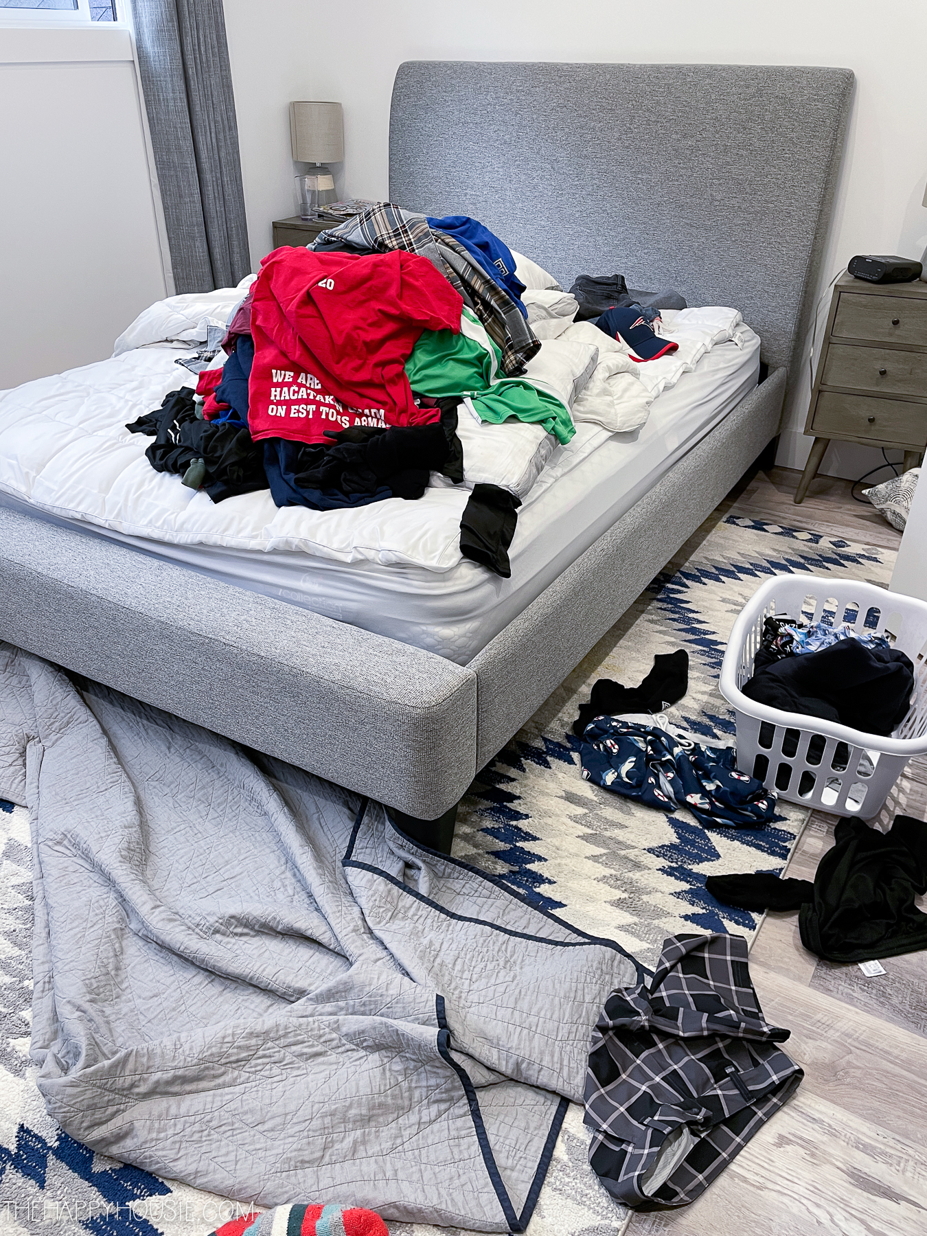 room organization ideas picture of clothes all over a bed being sorted to purge or keep