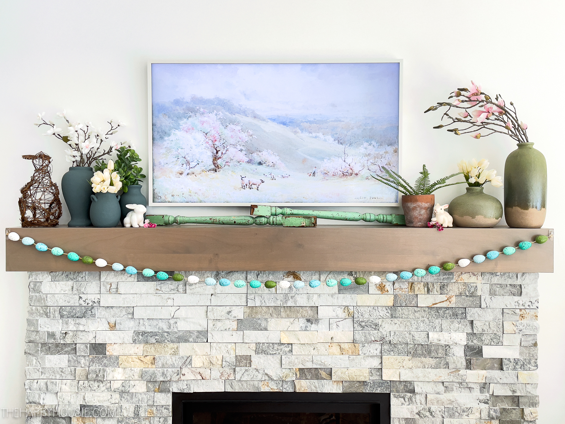 spring and Easter decor on a stone and wood fireplace mantel 