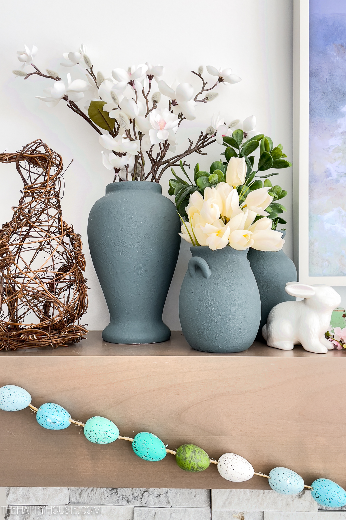 faux spring blooms displayed on a spring mantel 