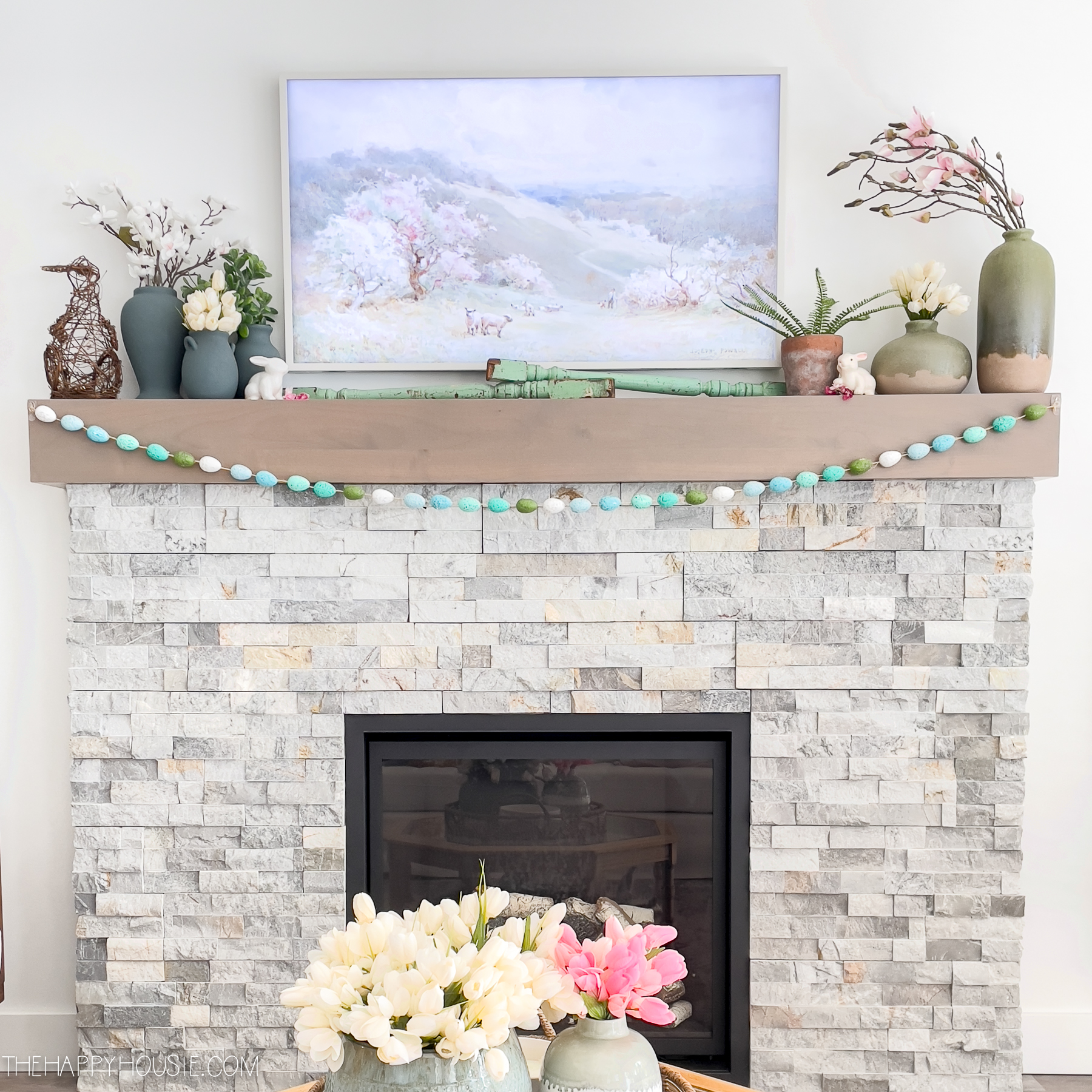 stone fireplace with wood mantel Easter decor on mantel
