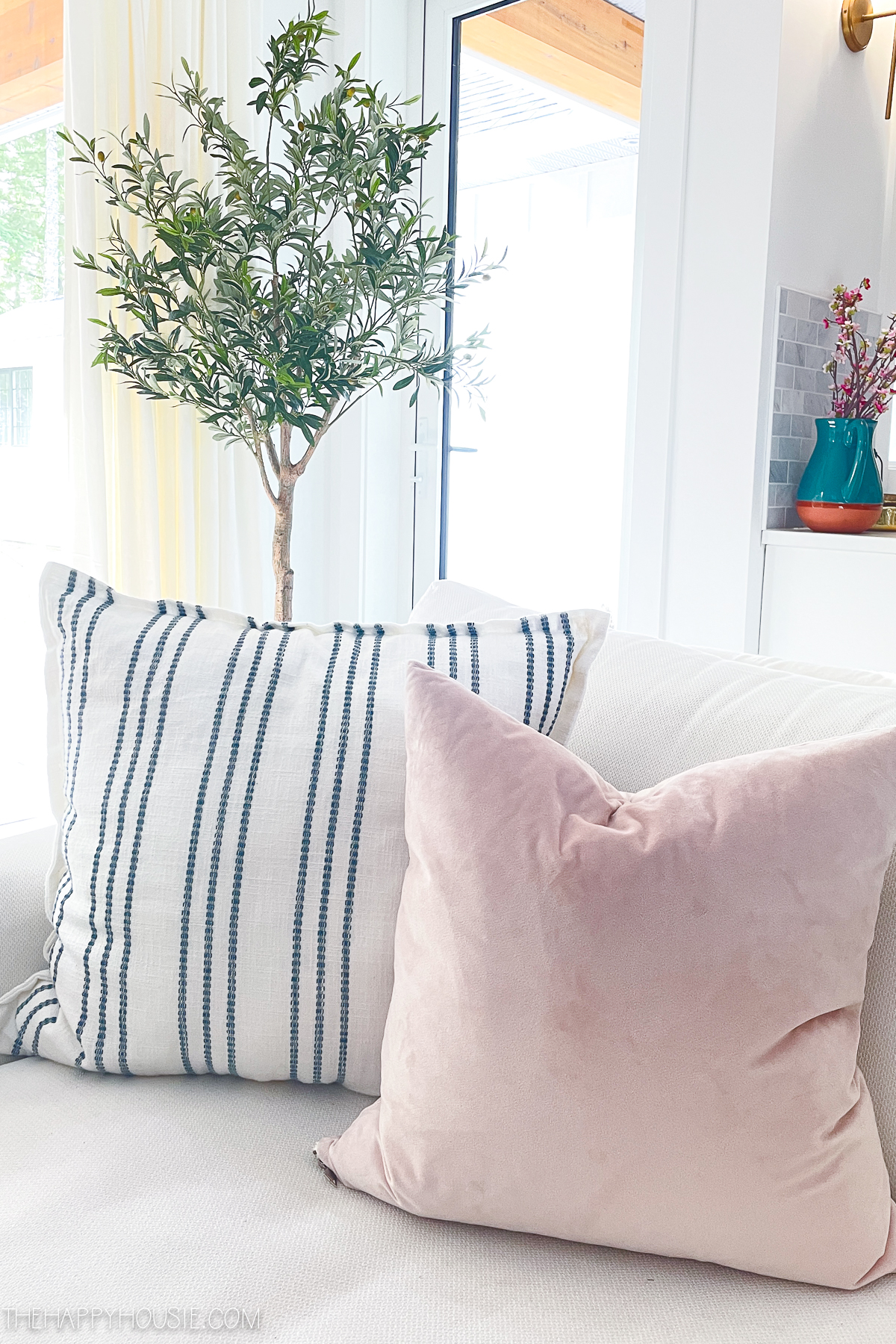 pink and white pillows in a spring living room space