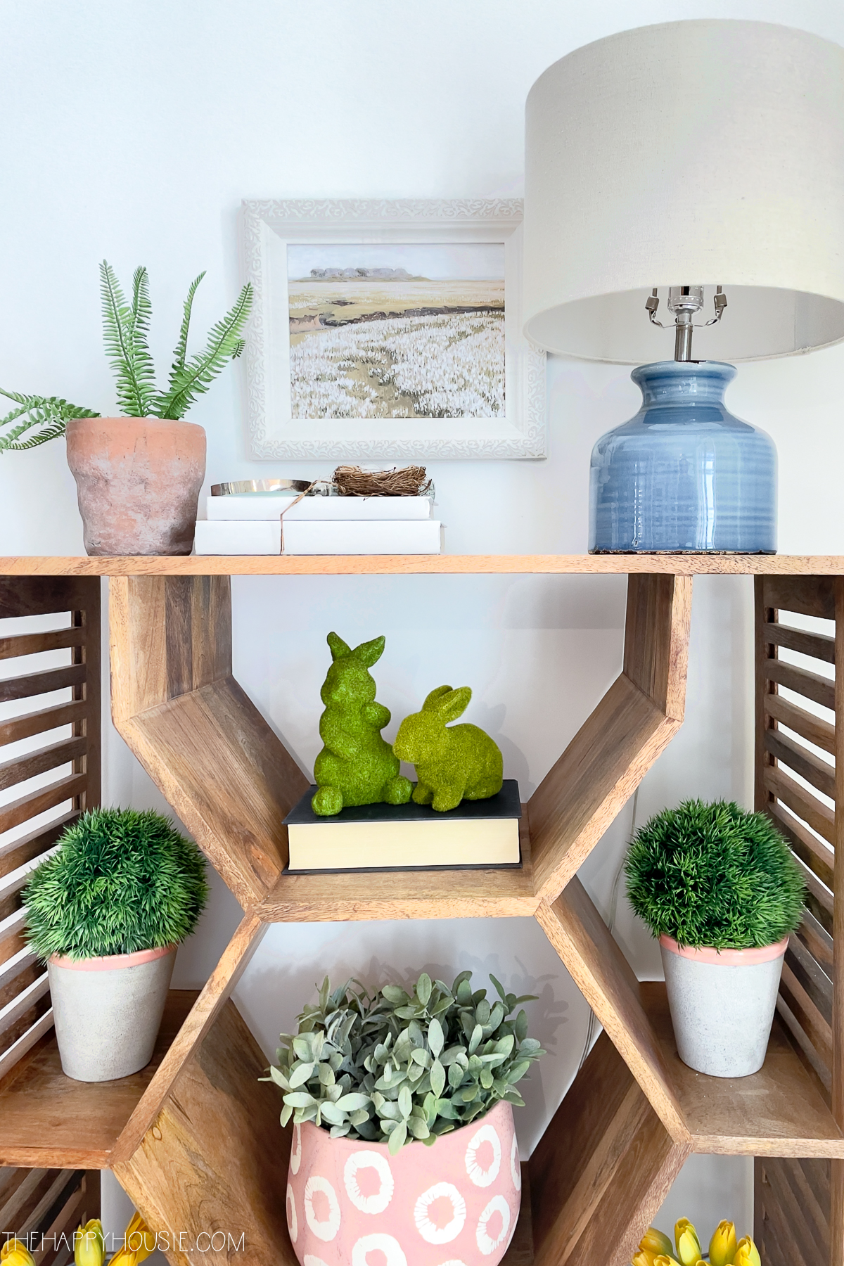 a modern bookshelf with spring decorations