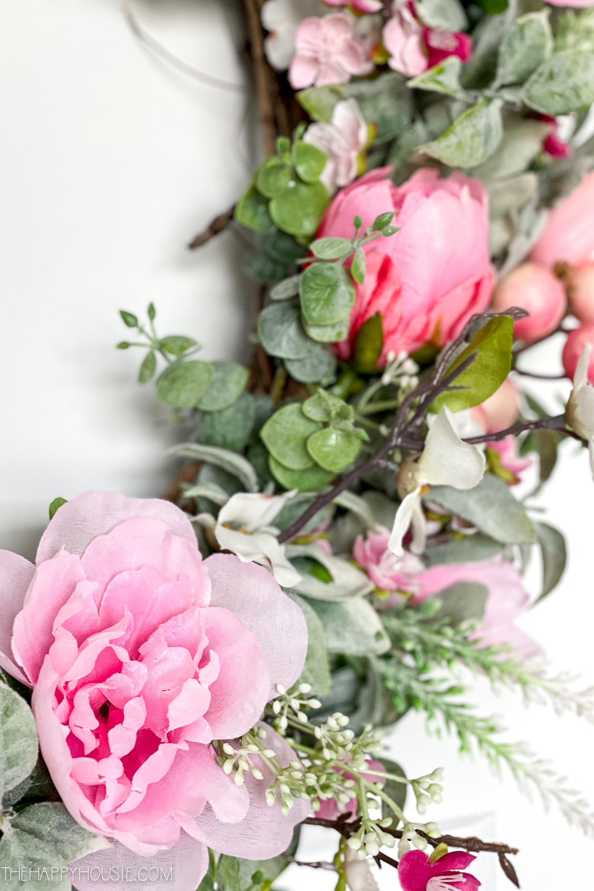 pink faux blossoms on a DIY spring wreath