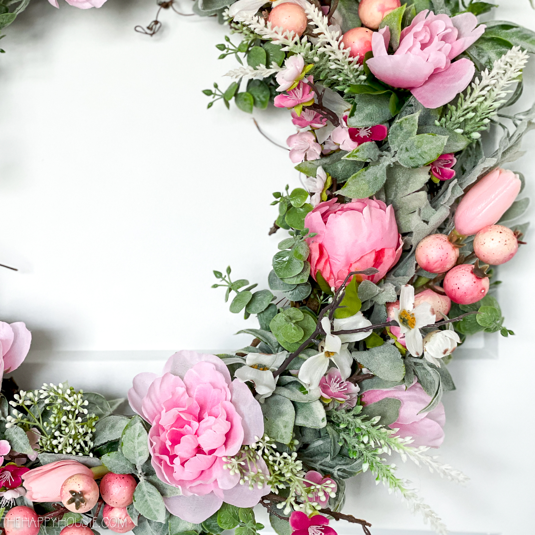 lower section of a DIY spring wreath with pink blossoms