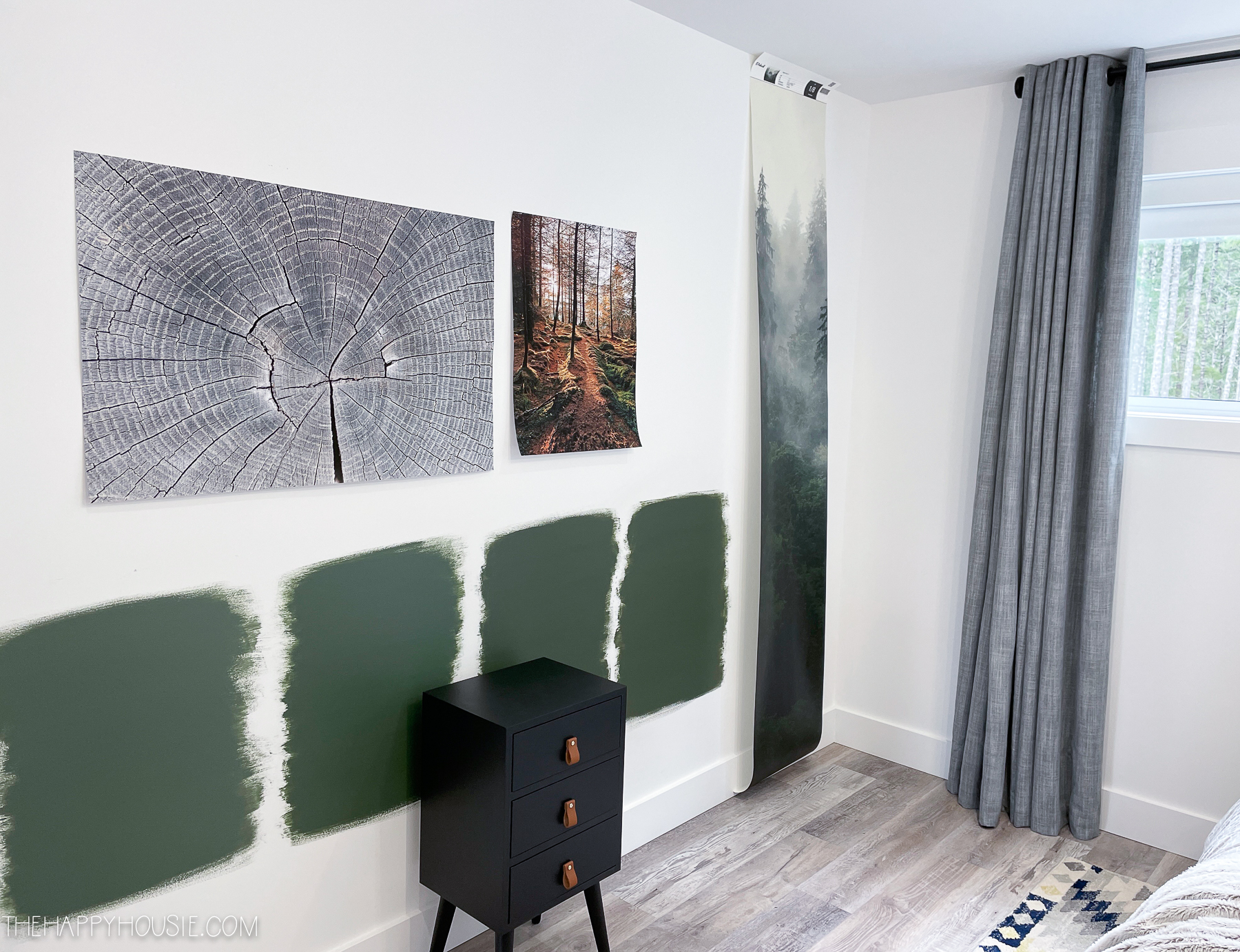 four samples of dark green paint colors on the wall