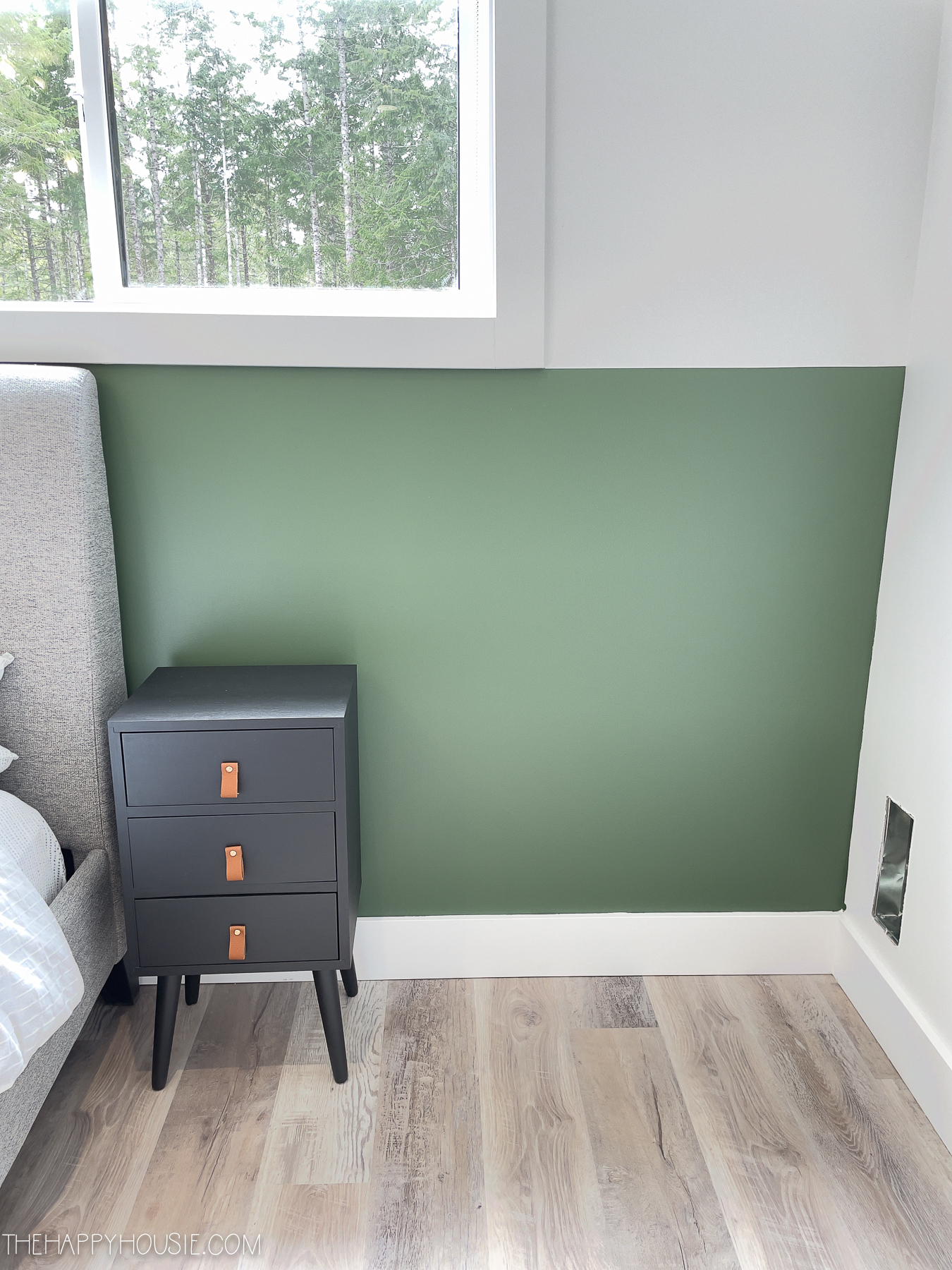 Benjamin Moore Peale Green painted on half wall with black nightstand in front