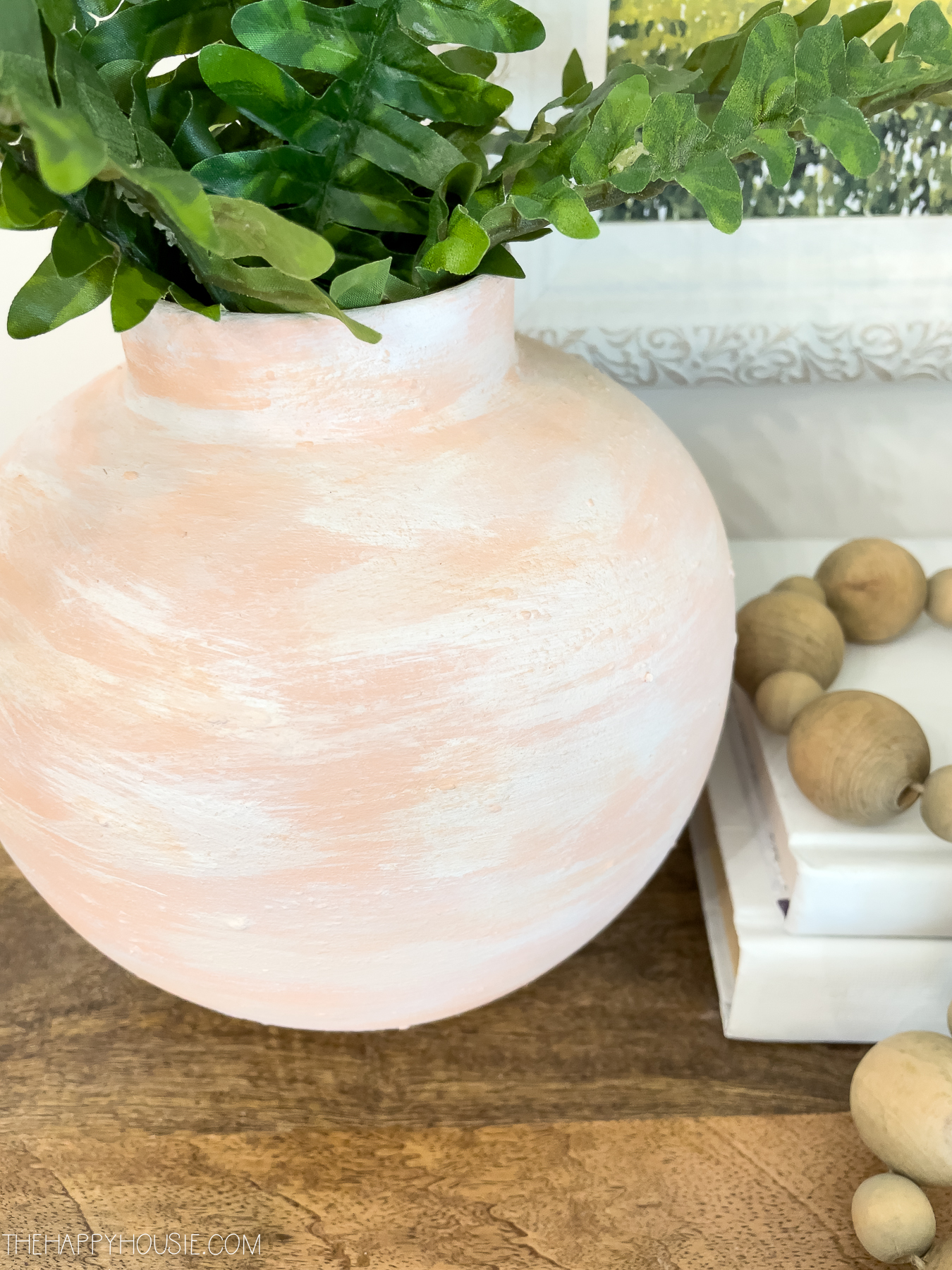 a faux terracotta looking vase styled