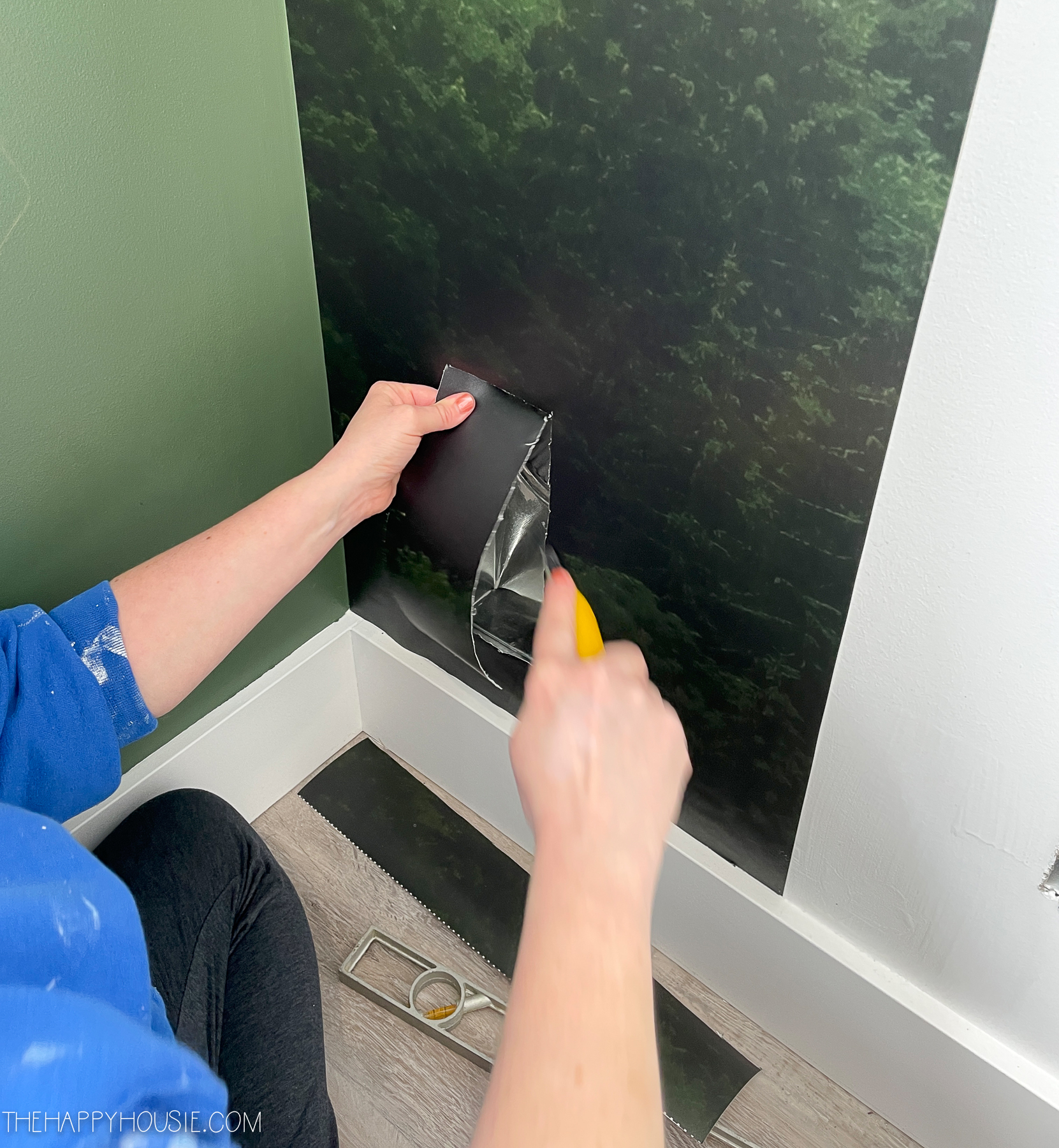 cutting the mural wallpaper around the wall vent