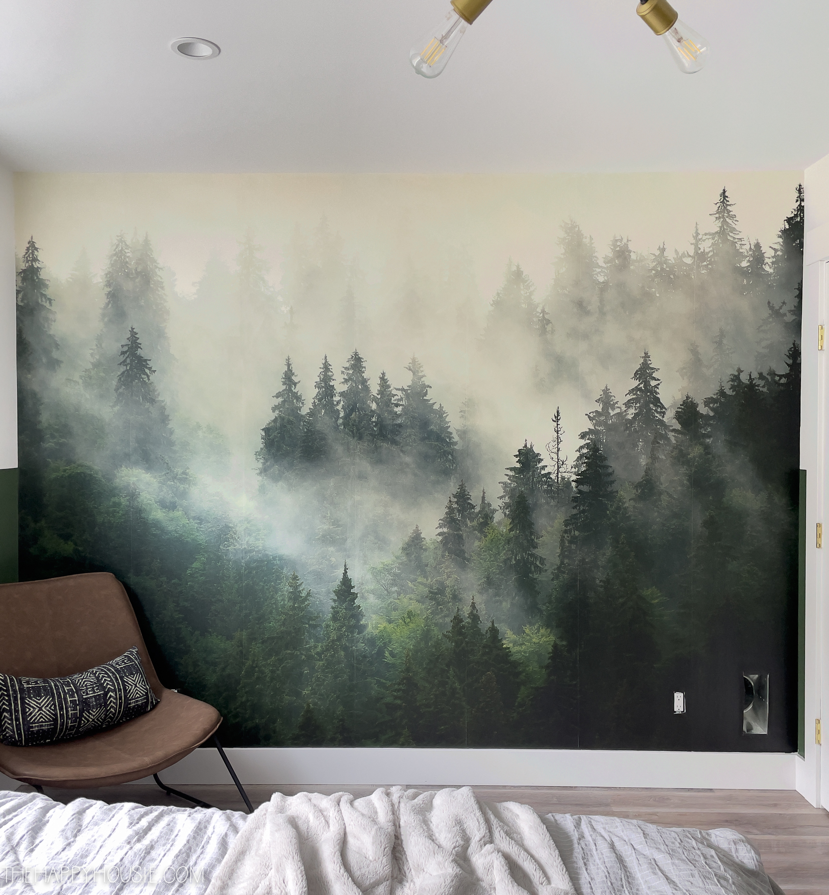Photowall Sweden foggy forest wallpaper mural installed in a bedroom