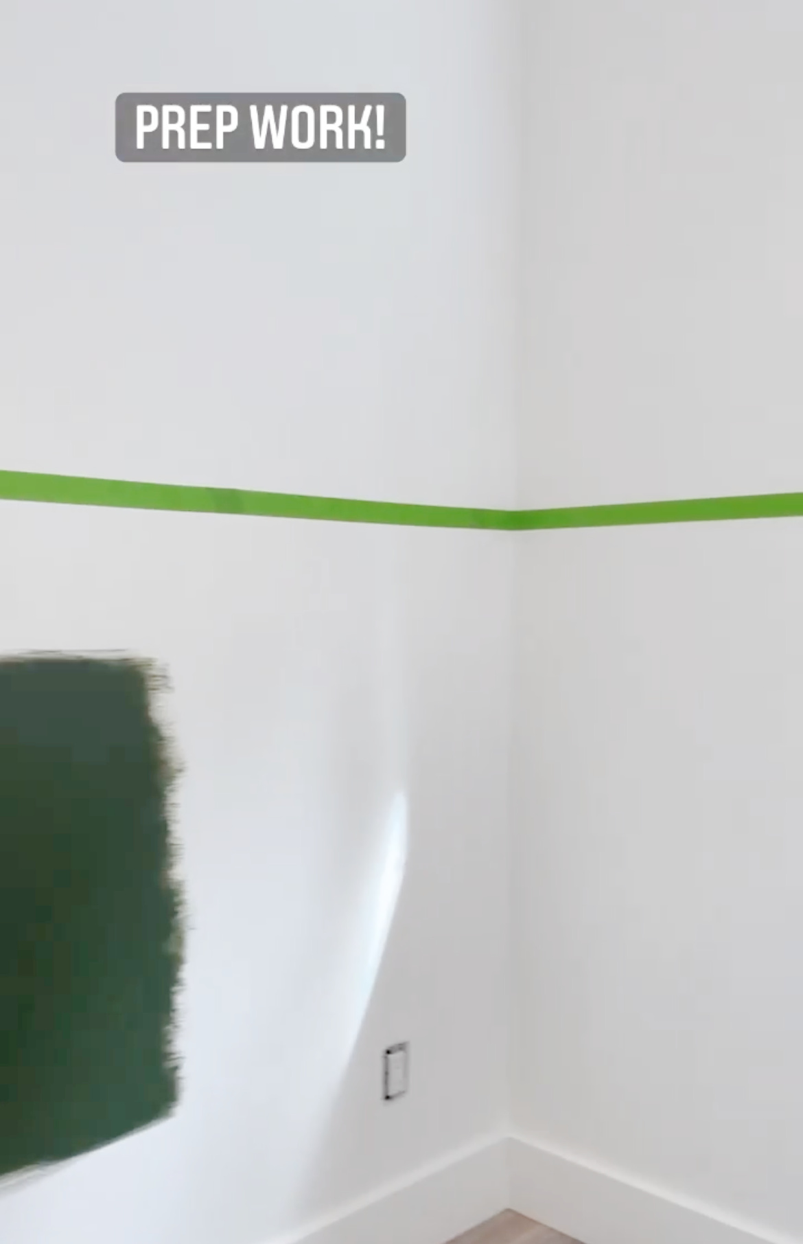 painters tape applied to the wall to paint a half wall