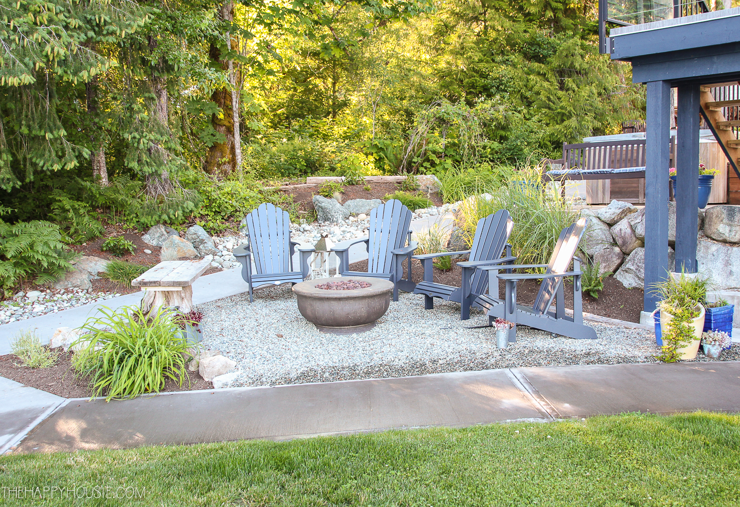 a pea gravel patio area tucked between two converging sidewalks in a yard